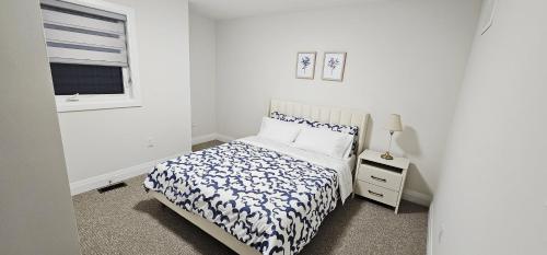 a white bedroom with a bed and a window at Muskoka Luxury Getaway in Gravenhurst