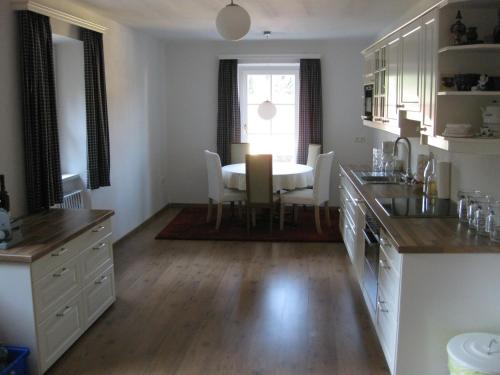 a kitchen with a table and a dining room at Villa Domus in Krems an der Donau