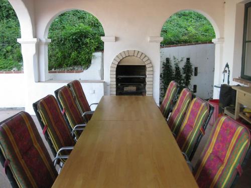 a long table and chairs in a room with a piano at Villa Domus in Krems an der Donau