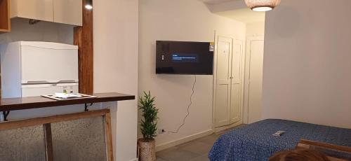 a small room with a tv on the wall at Departamento a dos cuadras de paseo Aldrey in Mar del Plata