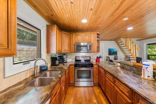 a kitchen with wooden cabinets and stainless steel appliances at On The Rocks in Sevierville