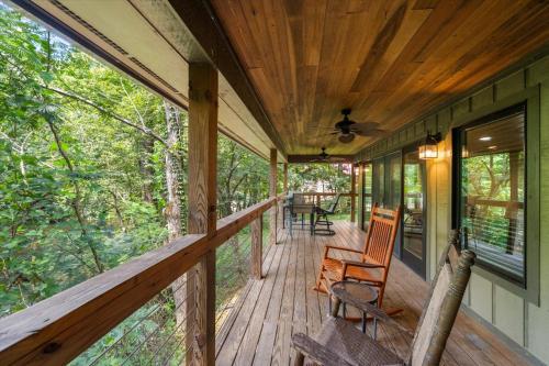 a wrap around porch with chairs and a ceiling fan at On The Rocks in Sevierville