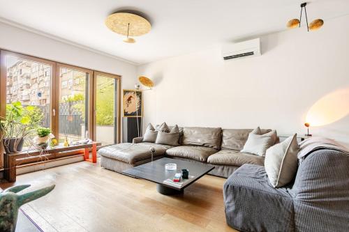 a living room with a couch and a table at Garden Oasis in City Center in Belgrade