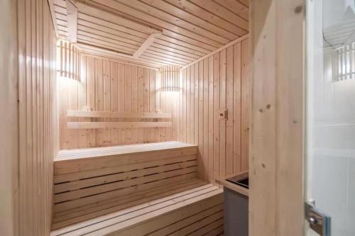 a wooden sauna with a bench in a wooden at Hyde Sukhumvit 11 Bankok in Bangkok