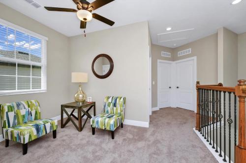a living room with two chairs and a ceiling fan at Inviting Home Near Disney With Waterpark & Resort Access At Encore Resort - 7792Sw in Kissimmee
