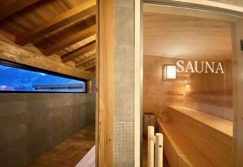 a bathroom with a sauna sign on a glass door at Résidence Les Rosiers - Chalet Rosiers - 10 Personnes - Morzine/Montriond MAE-3901 in Montriond