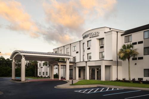 a rendering of the front of a hotel with a parking lot at Courtyard Brunswick in Brunswick