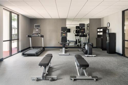 a gym with several exercise equipment in a room at Courtyard Brunswick in Brunswick