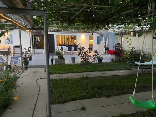 an outdoor patio with a swing in a yard at Köpingebro in Köpingebro