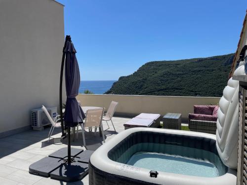 a bath tub sitting on top of a patio at Villino con terrazzo panoramico in Finale Ligure