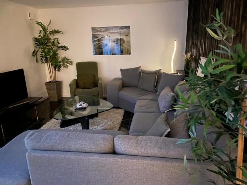 a living room with a couch and a table at Köpingebro in Köpingebro