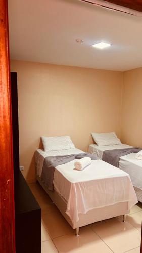 a room with two beds in a room at Flat Residencial dos Anjos in Maceió