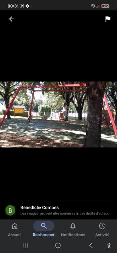 a picture of a park with a red structure at Maison spacieuse 8 couchages proche cascade lac et base de loisirs et de bien être in Lacaze