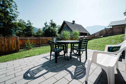 a table and chairs sitting on a patio at Mitzis Stubn Apartments - pets no extra cost - Bad Goisern - 24-hour self check-in in Bad Goisern