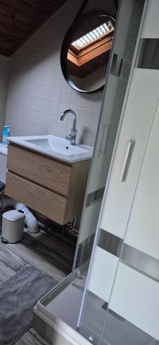 a bathroom with a sink and a mirror at Chambre Étape Carosselle in Saint-Vaury