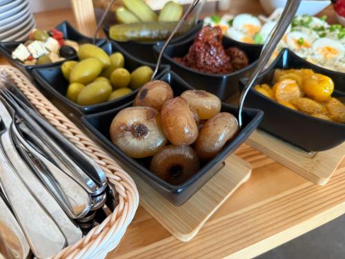 a table topped with trays of different types of food at Bella Monte in Szczyrk