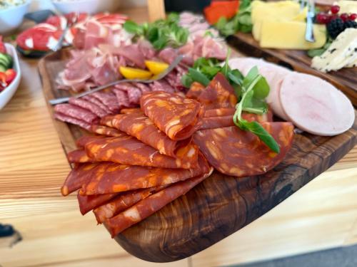 a plate of meat and other food on a table at Bella Monte in Szczyrk