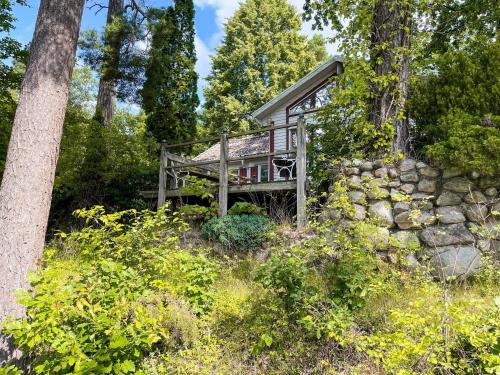a cabin in the woods with a stone wall at 4 star holiday home in TYRINGE in Tyringe