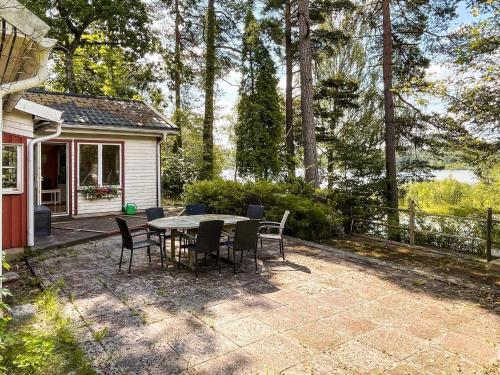 a patio with a table and chairs in front of a house at 4 star holiday home in TYRINGE in Tyringe