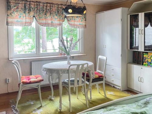 a dining room with a table and two chairs at 4 star holiday home in TYRINGE in Tyringe
