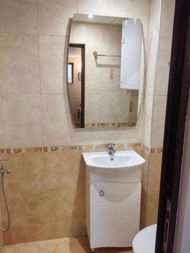 a bathroom with a sink and a mirror at Апартамент Мария in Bansko