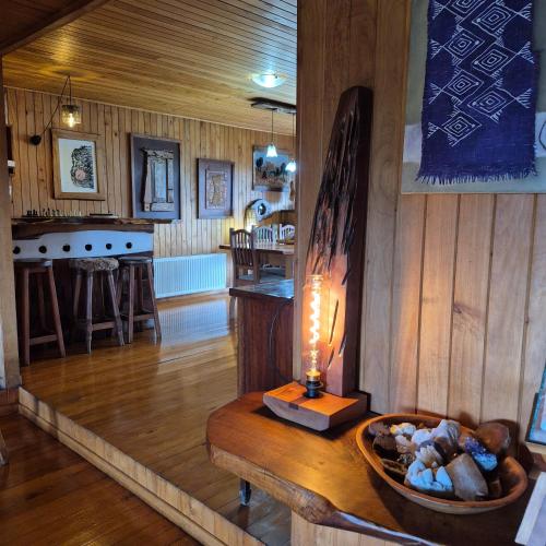 a living room with a table with a lamp on it at Hostal Boutique El Vergel Azul in Castro