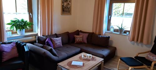 a living room with a couch and a table at Fewo Steinbeisser in Arrach