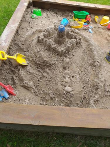 a sand castle in a sandbox with toys in it at Fewo Steinbeisser in Arrach