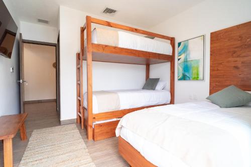 a bedroom with two bunk beds and a desk at Designer Villa with Direct Pool Access in La Candelaria