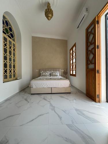 a bedroom with a bed and a large marble floor at Marshall property in Tangier