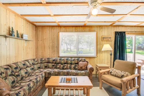a living room with a couch and a table at Muskie Cabin on Mille Lacs Lake Boat and Fish! in Garrison