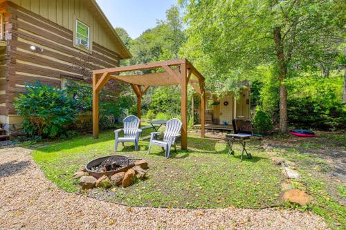 a patio with two chairs and a table and a fire pit at Riverfront Home with Fire Pit and Deck in Lansing in Lansing