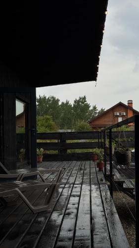 a deck with chairs sitting on top of it at шАлАш in Velikiye Lazy