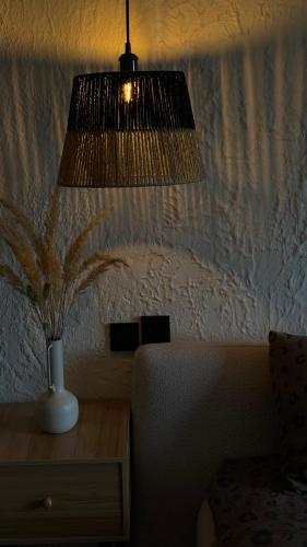 a room with a vase on a desk with a lamp at шАлАш in Velikiye Lazy