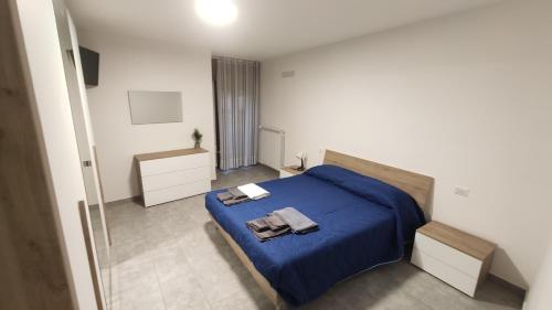 a bedroom with a blue bed with towels on it at Il Fungo in Cusano Mutri