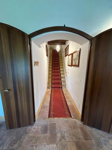 a long hallway with a red carpet and a stairway at BolognaRoomscom - Ca' Palazzo in Sasso Marconi