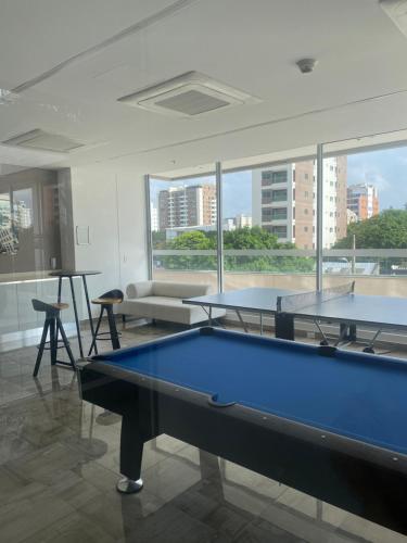 two pool tables in a room with a large window at Distrito 90 luxury suites in Barranquilla