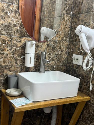 a bathroom with a white sink and a mirror at Готель TWINS РАЙ in Vorokhta