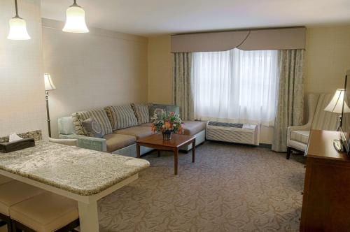 a living room with a couch and a table at The Inn at Lewisburg, BW Signature Collection in Lewisburg