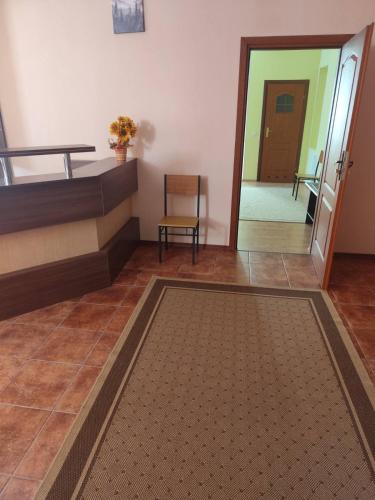 a room with a bed and a hallway with a mirror at VerhHouse in Yaremche