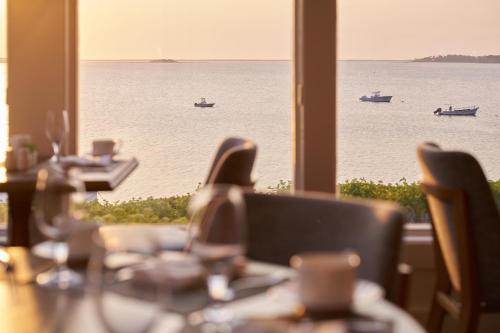 a table with a view of the water and boats at Wequassett Resort and Golf Club in East Harwich