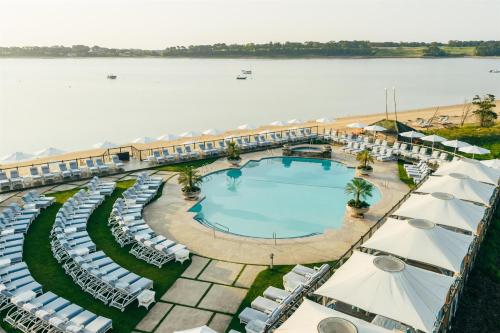 an aerial view of a resort with a pool and umbrellas at Wequassett Resort and Golf Club in East Harwich