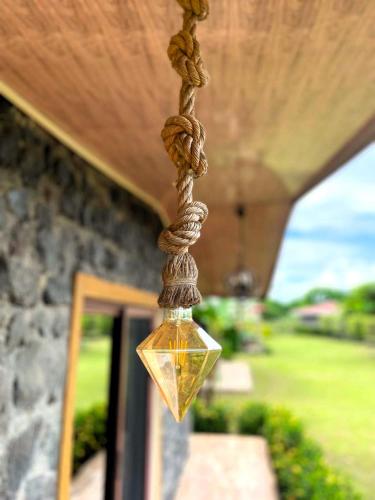 a light with a rope hanging from a porch at Cabañas El Manantial in Esquipulas