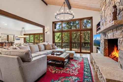 a living room with a couch and a fireplace at Private Ski-out Village Home in Vail with Hot Tub in Vail