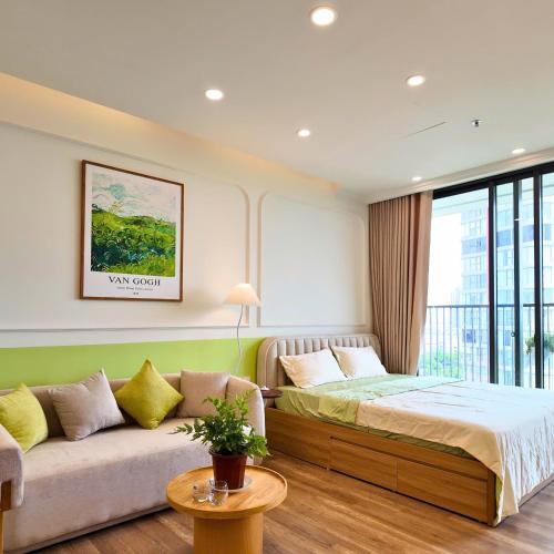 a bedroom with a bed and a couch and a window at Swanlake ecopark Hanoi-Calm homestay in Kim Quan