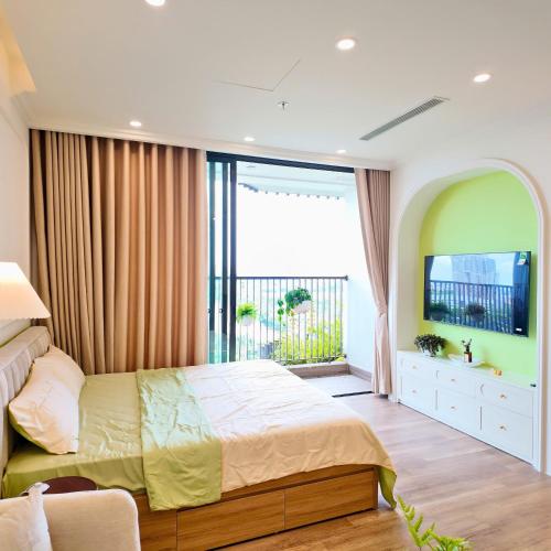 a bedroom with a bed and a flat screen tv at Swanlake ecopark Hanoi-Calm homestay in Kim Quan