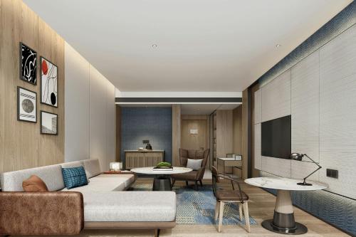 a living room with a couch and a table at Four Points by Sheraton Ji’an in Ji'an