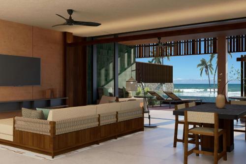 a living room with a couch and a table at Siari, a Ritz-Carlton Reserve 
