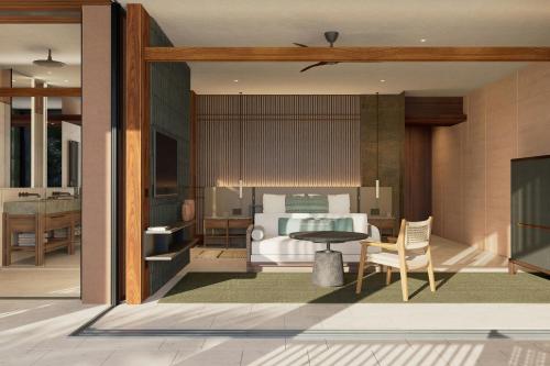 a bedroom with a bed and a table at Siari, a Ritz-Carlton Reserve 
