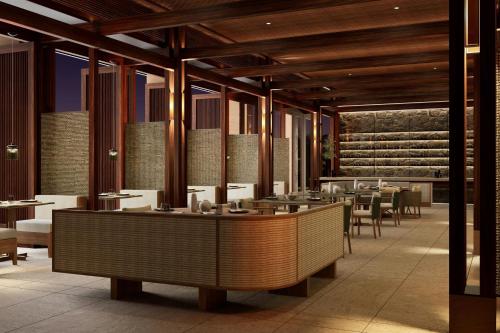 a restaurant with tables and chairs in a room at Siari, a Ritz-Carlton Reserve 